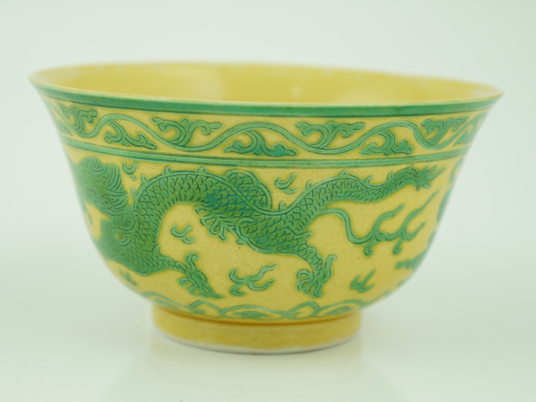 A Chinese green and yellow glazed 'dragon' bowl, Daoguang mark and of the period (1821-50), section of rim broken and restored, hairline cracks